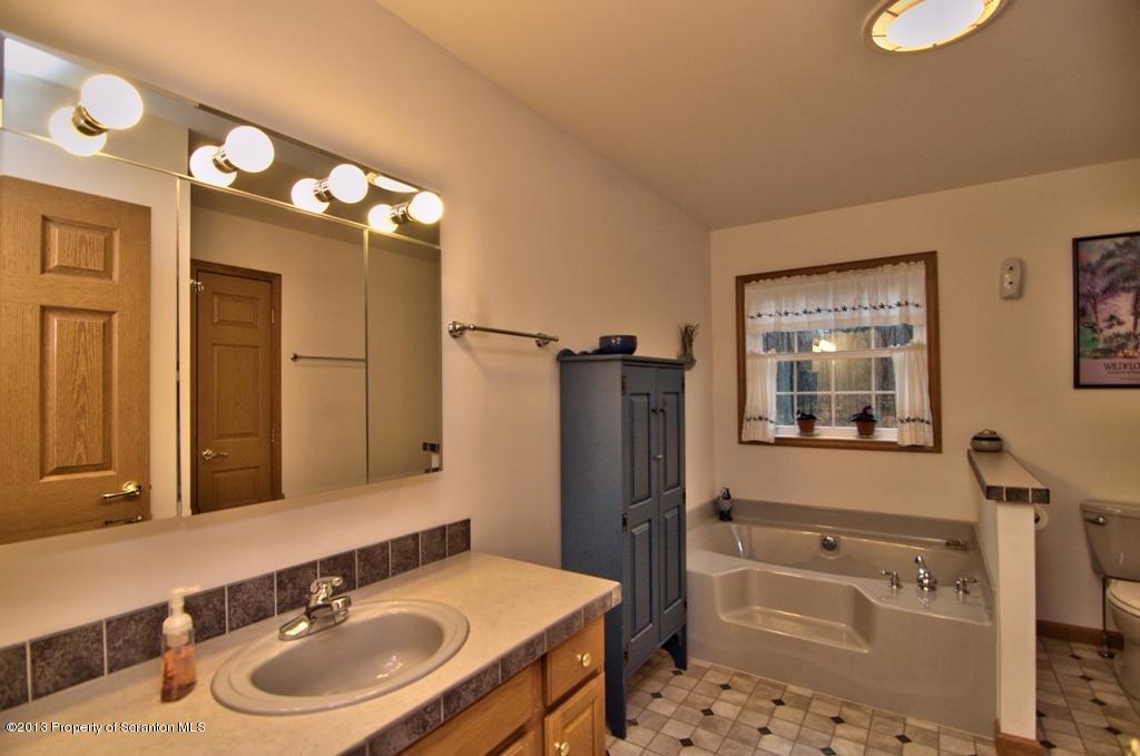 1633 Howe Road Moscow, PA 18444 - Photo 8 of 59 a bathroom with a sink vanity granite tub and shower