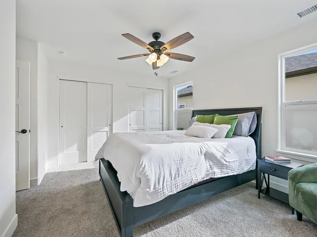 a bedroom with a bed and a chandelier