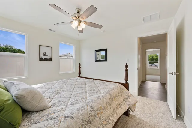 a bedroom with a large bed and a chandelier