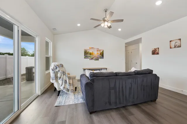 a living room with furniture and a chandelier