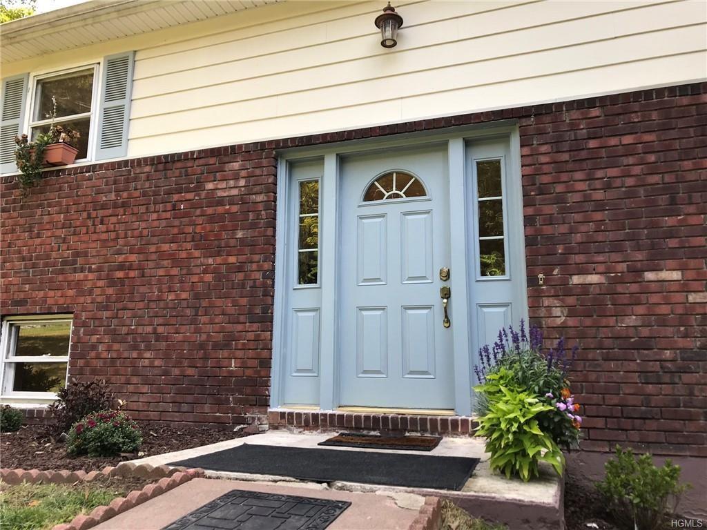 64 Roselawn Road Highland Mills, NY 10930 - Photo 1 of 1 a front view of a house with a yard