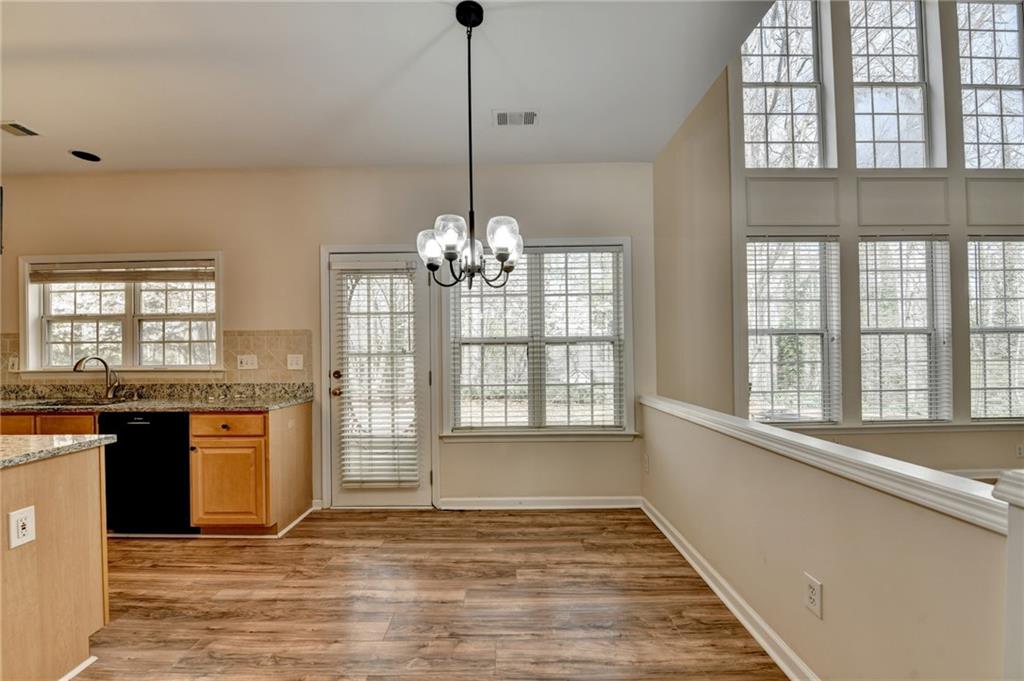 100 Hawnley Trc Northwest Suwanee, GA 30024 - Photo 23 of 58 a view of an empty room with a kitchen sink and wooden floor