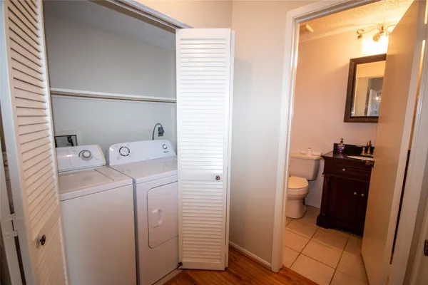 a view of a storage & utility room with two washing machine