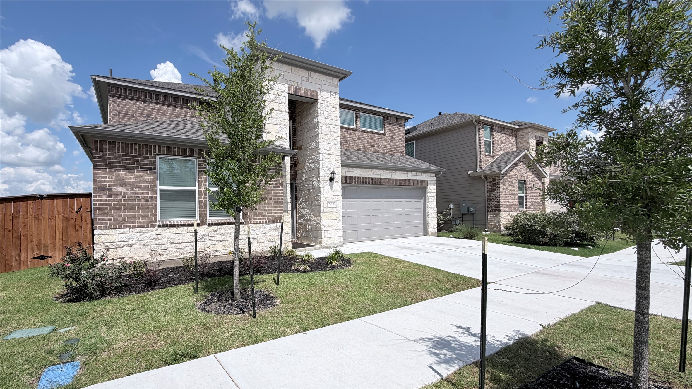 2001 Wynn Road Hutto, TX 78634 - Photo 1 of 39 A newly constructed residence showcasing a harmonious blend of brick and stone masonry on its facade.