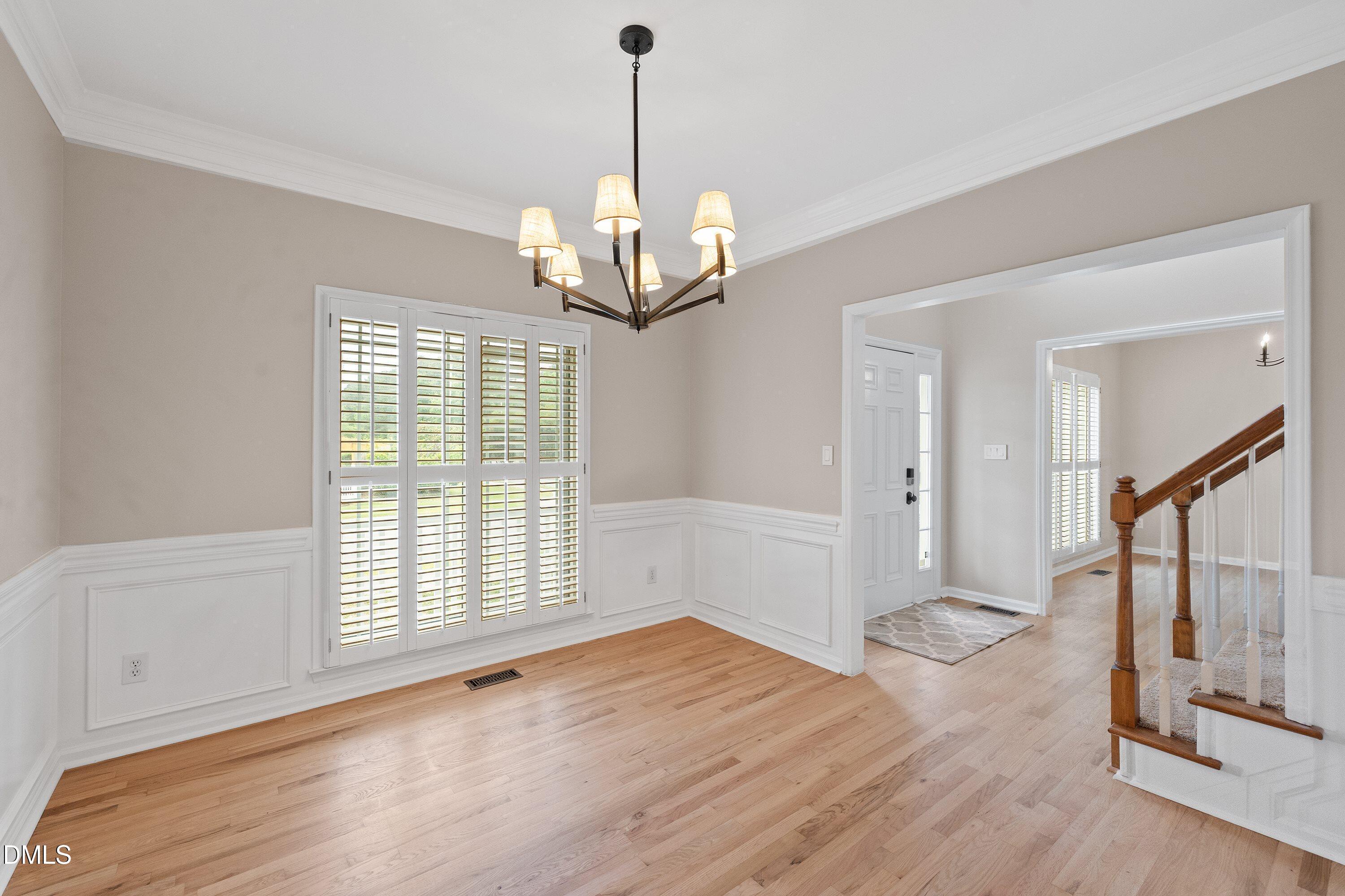 2428 Havershire Drive Raleigh, NC 27613 - Photo 12 of 53 a view of an empty room with wooden floor and a window