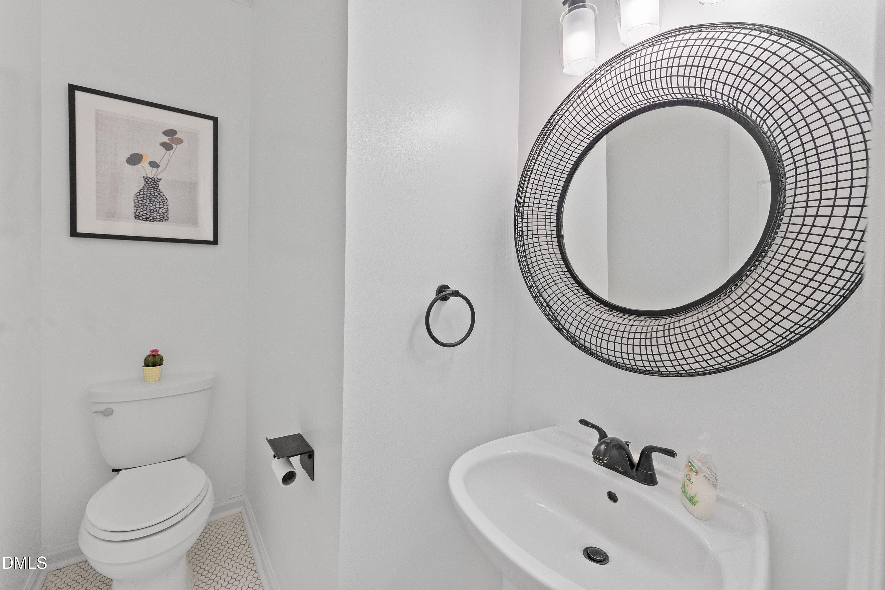 2428 Havershire Drive Raleigh, NC 27613 - Photo 14 of 53 a bathroom with a toilet a sink and mirror