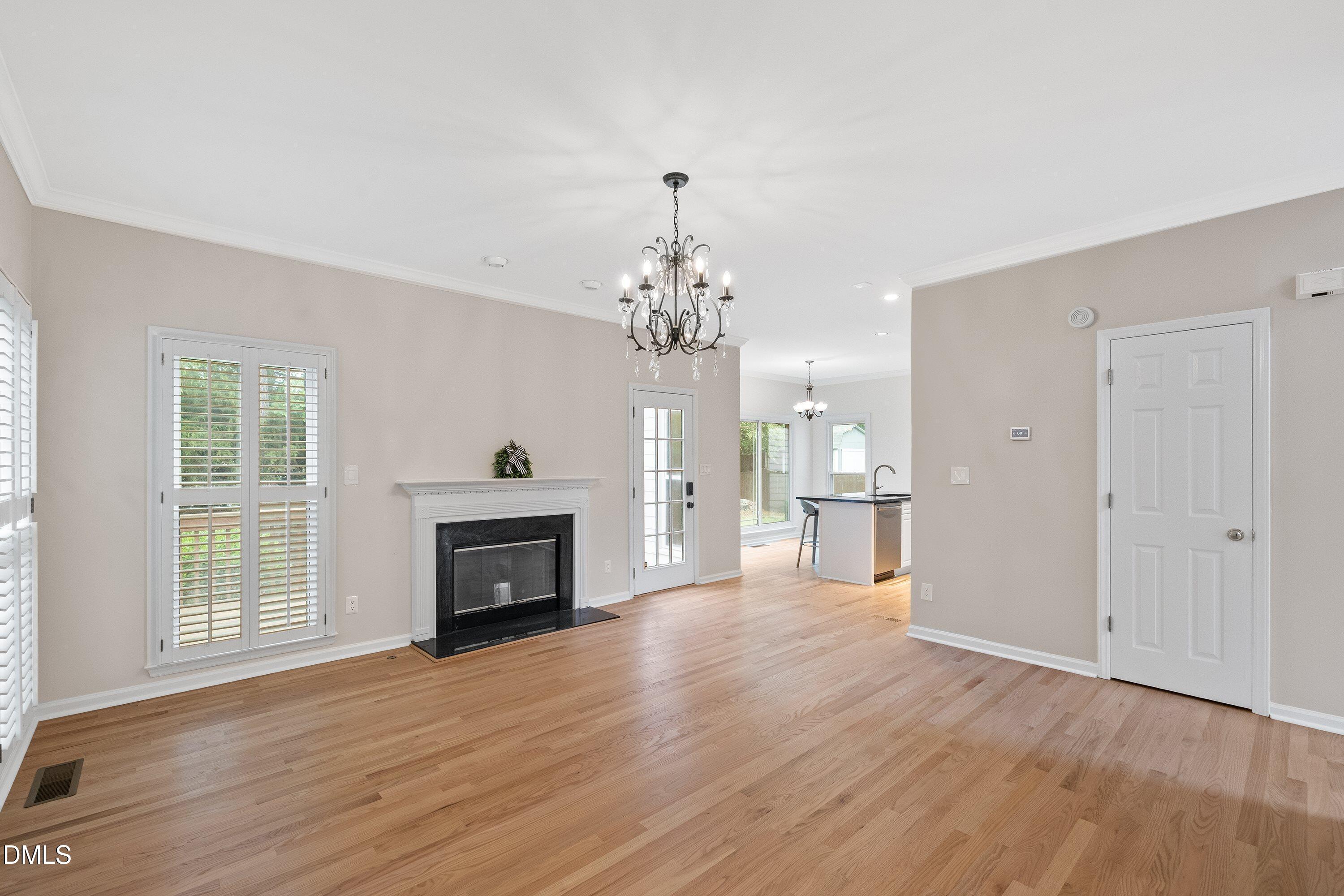 2428 Havershire Drive Raleigh, NC 27613 - Photo 17 of 53 a view of a room with wooden floor fireplace and windows