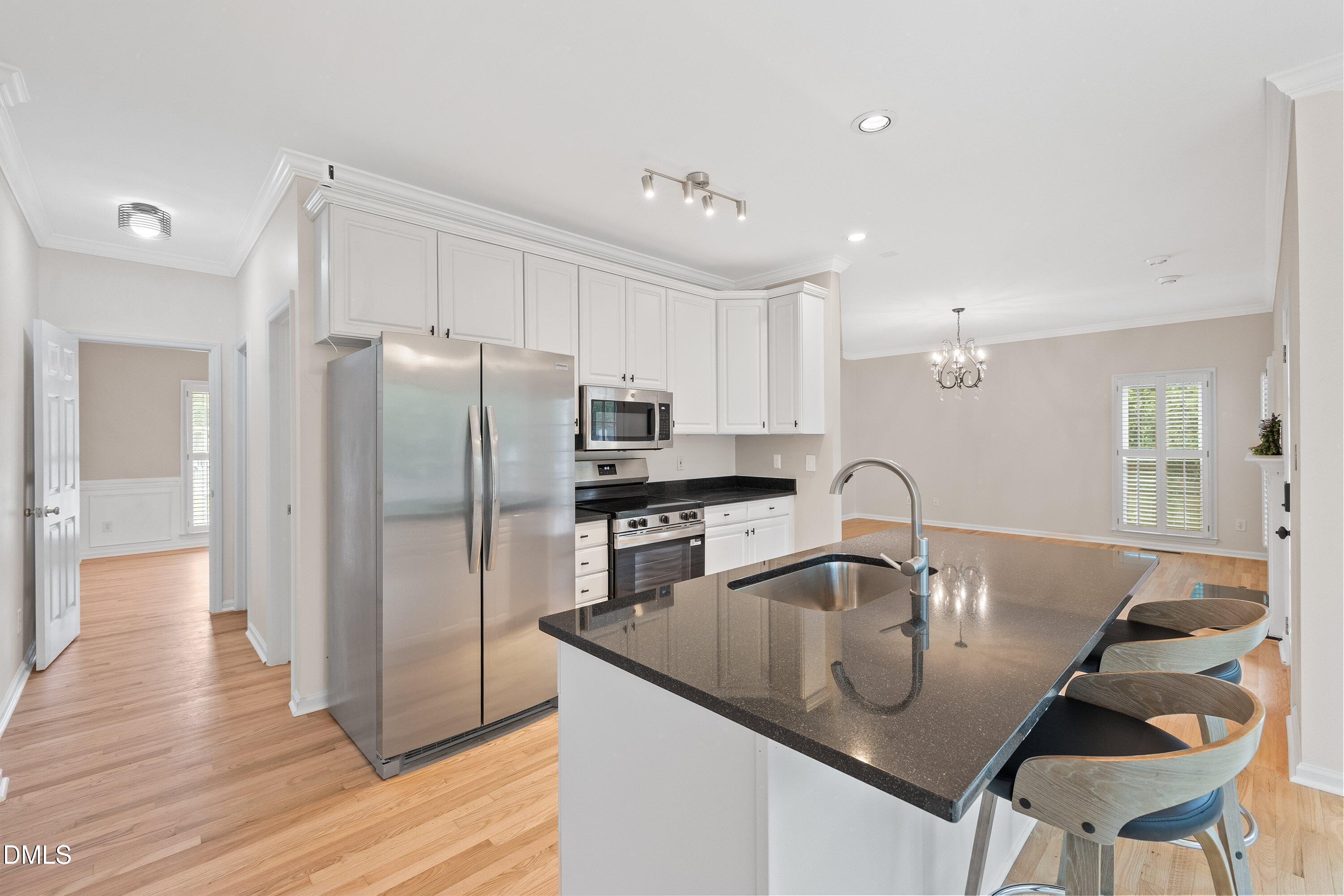 2428 Havershire Drive Raleigh, NC 27613 - Photo 21 of 53 a kitchen with stainless steel appliances granite countertop a sink a microwave and a refrigerator