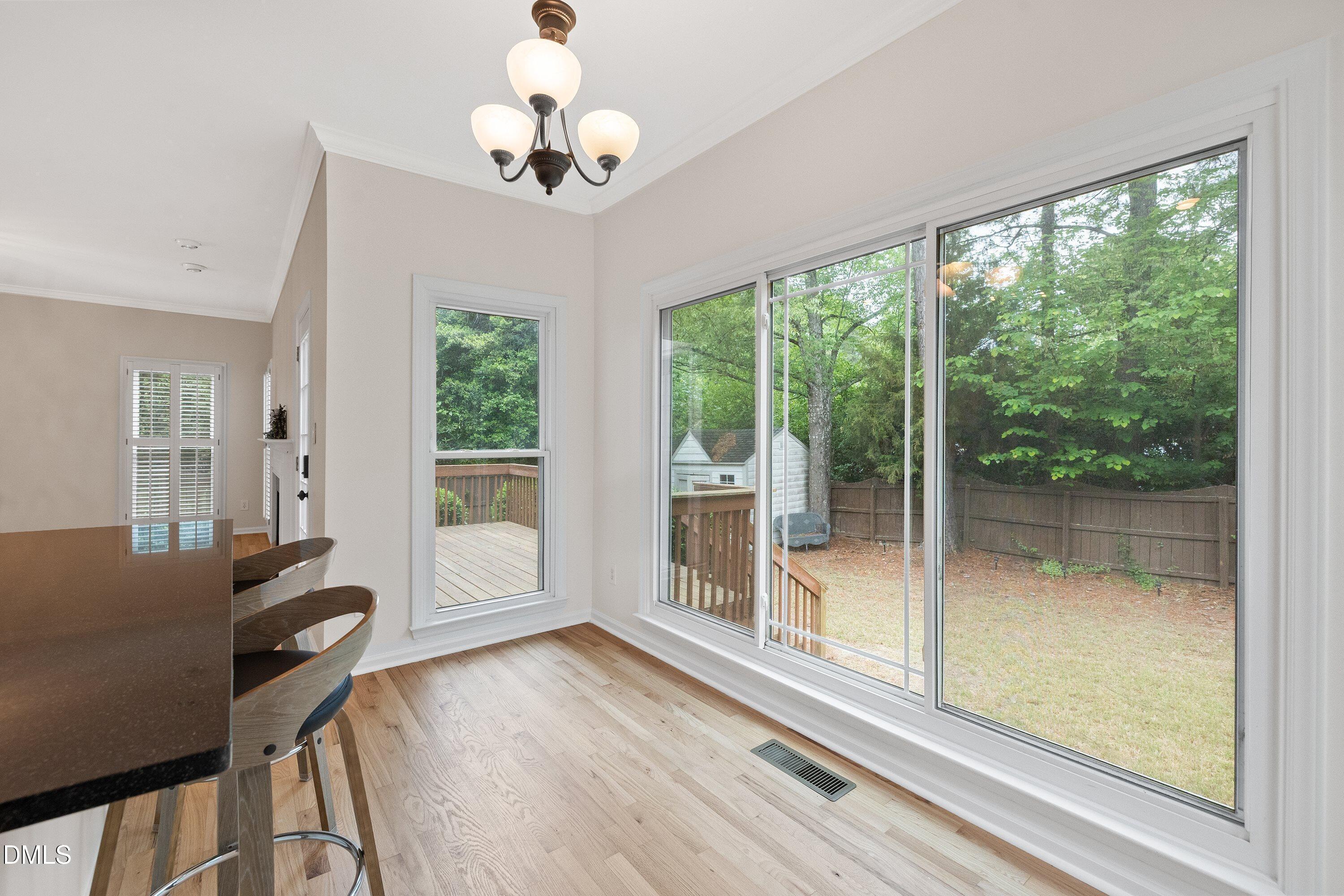 2428 Havershire Drive Raleigh, NC 27613 - Photo 26 of 53 a view of a livingroom with furniture wooden floor and a chandelier