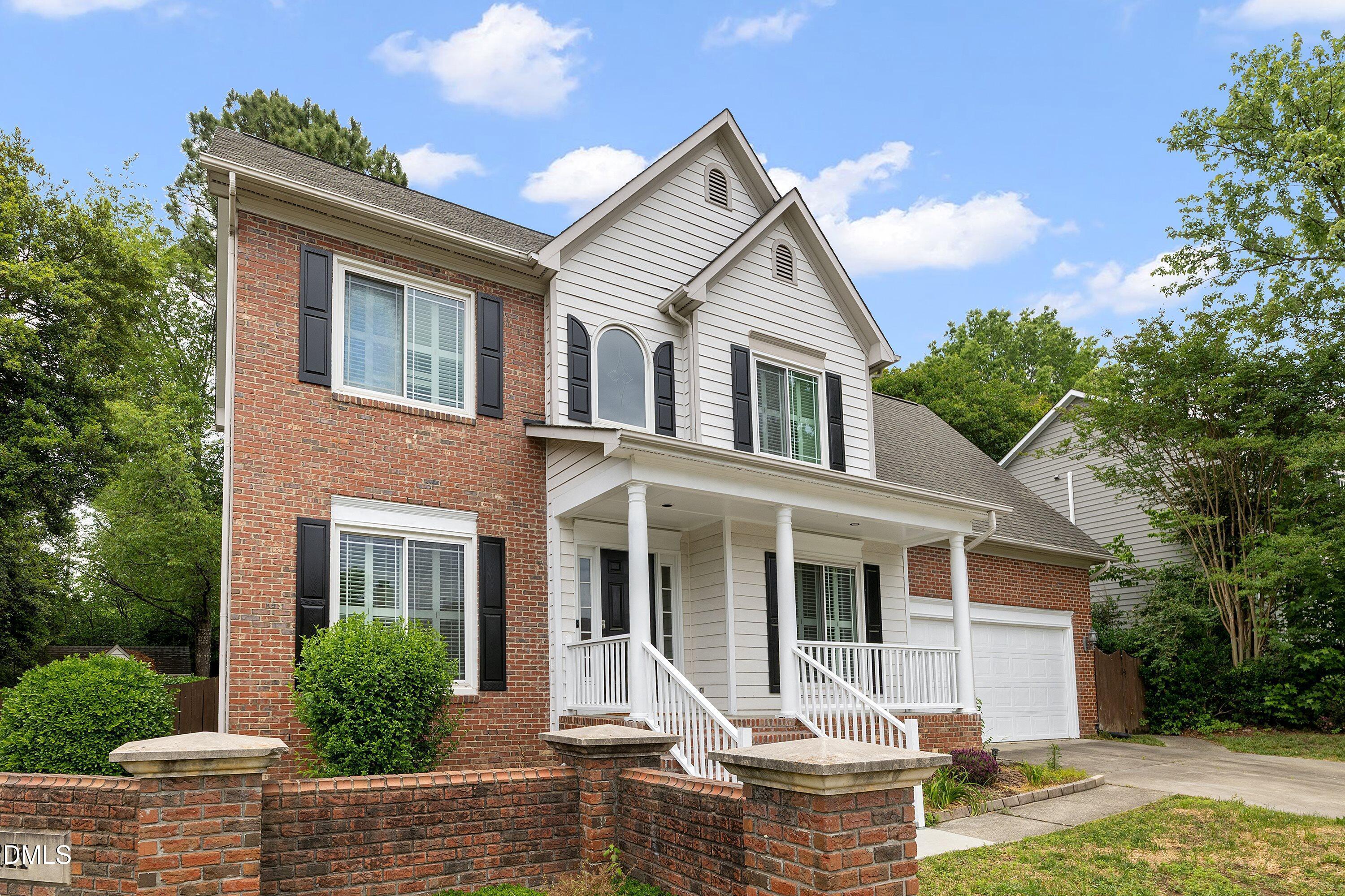 2428 Havershire Drive Raleigh, NC 27613 - Photo 5 of 53 a front view of a house with yard chairs and a tree