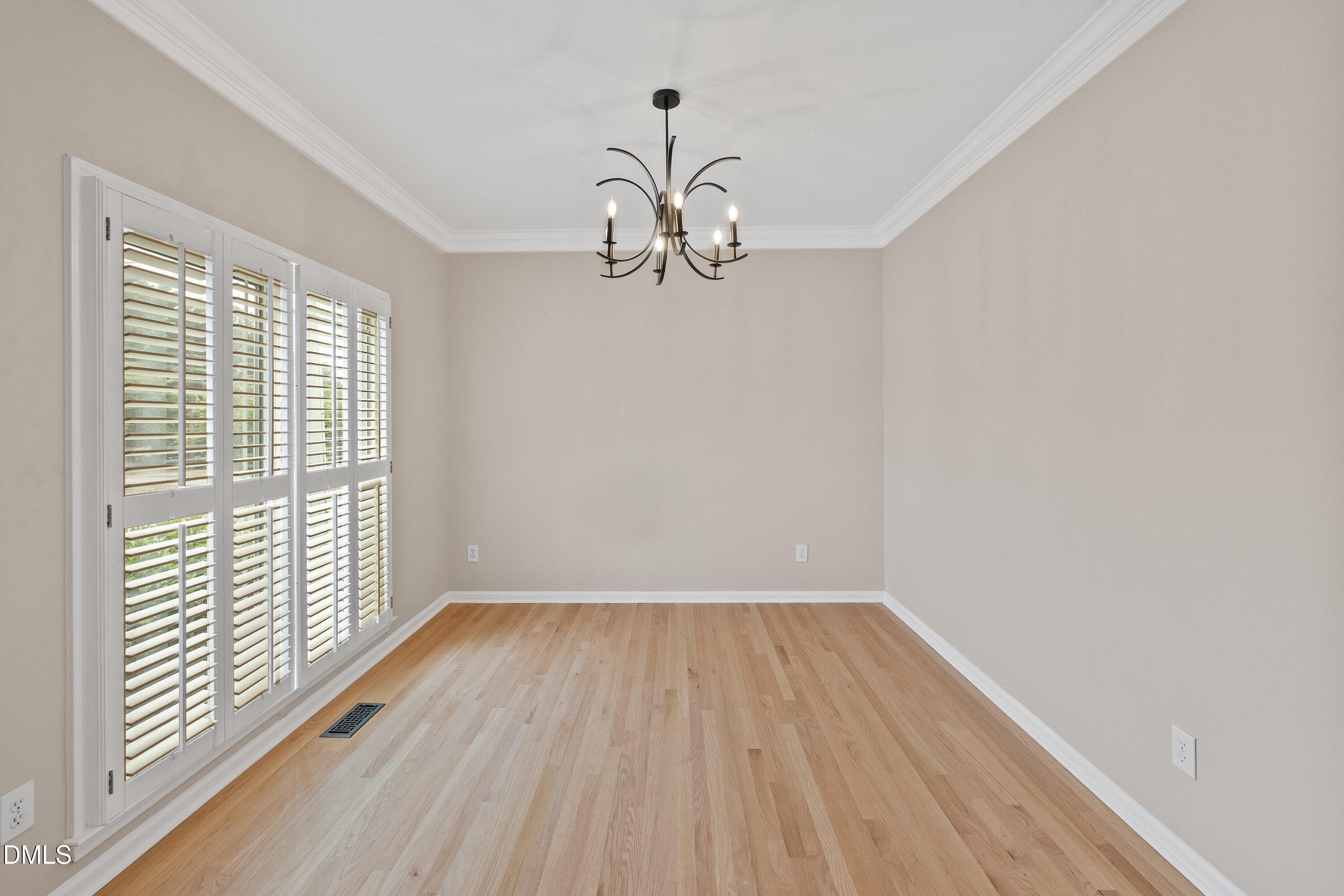 2428 Havershire Drive Raleigh, NC 27613 - Photo 10 of 53 a view of empty room with wooden floor and fan