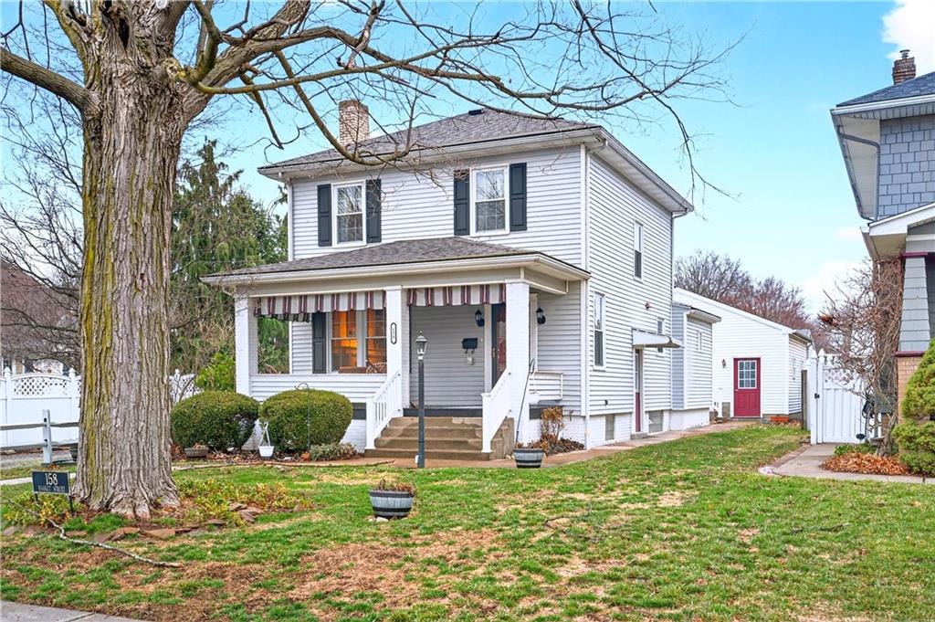 a front view of house with yard and green space