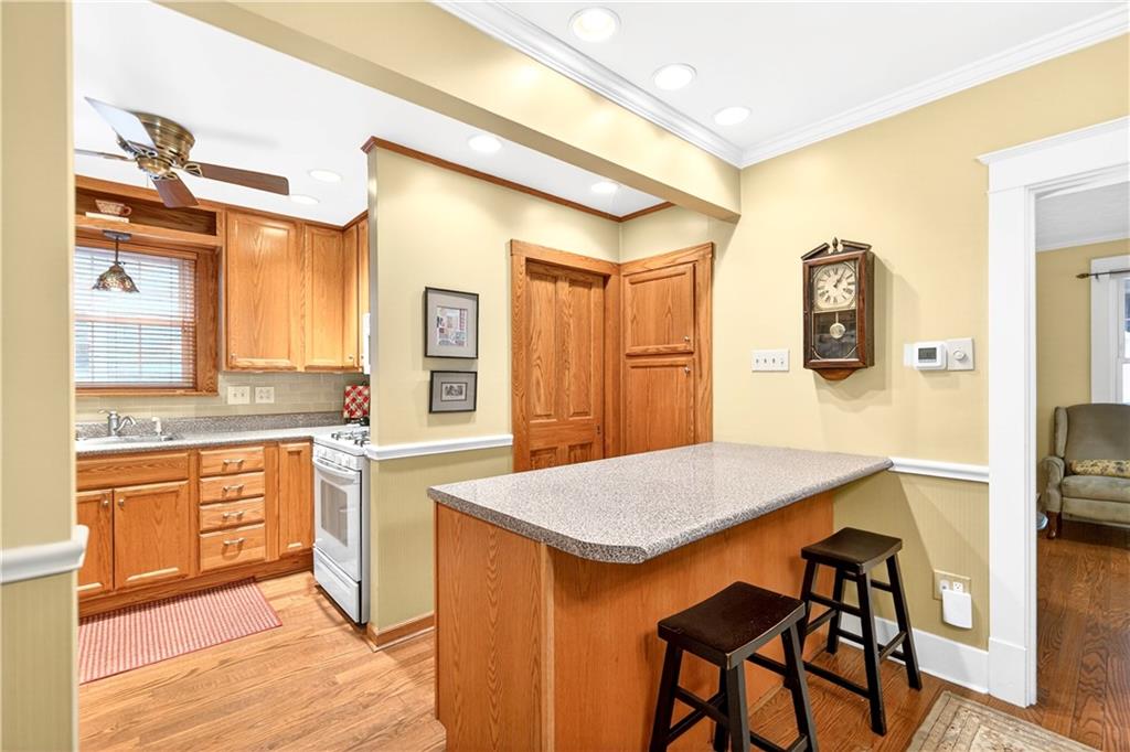 158 Market Street Beaver, PA 15009 - Photo 16 of 38 a kitchen with stainless steel appliances granite countertop a stove a sink dishwasher and a refrigerator with wooden floor