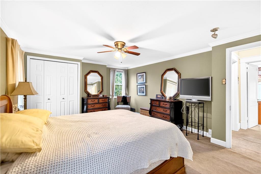 158 Market Street Beaver, PA 15009 - Photo 28 of 38 a bedroom with a bed large mirror on desk and a window