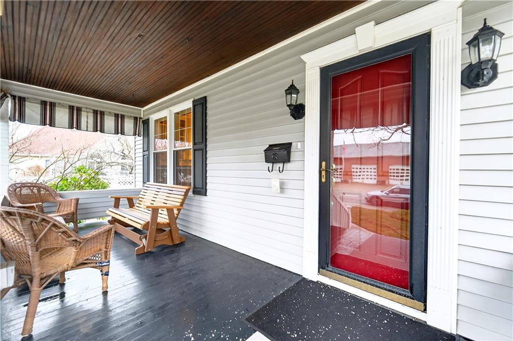 158 Market Street Beaver, PA 15009 - Photo 4 of 38 a porch with a bench and a potted plant on a wooden door