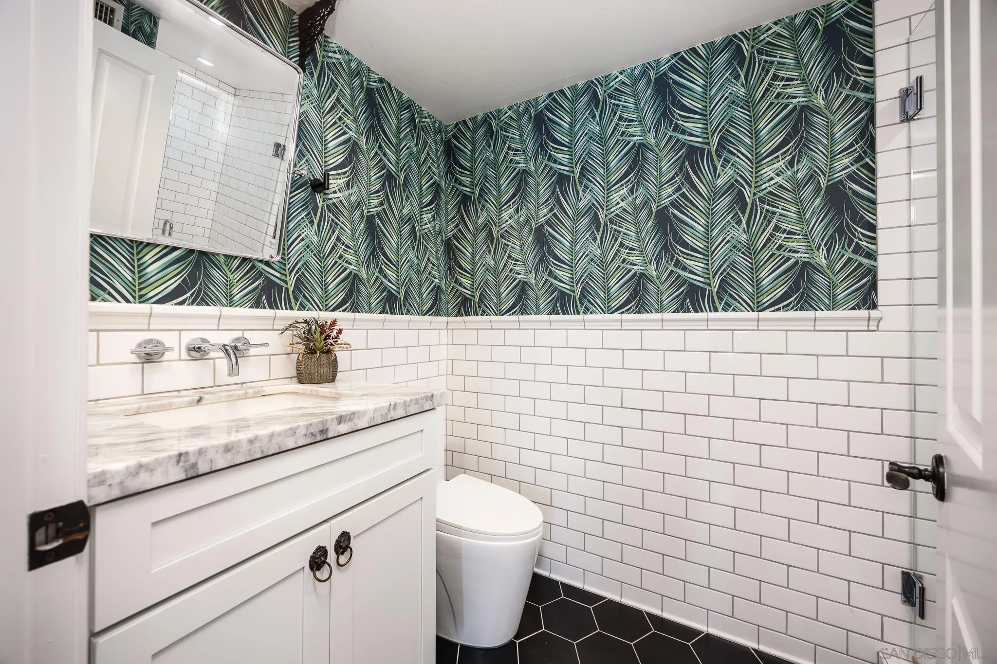3986 Riviera Drive San Diego, CA 92109 - Photo 11 of 35 a bathroom with a granite countertop sink a toilet and mirror