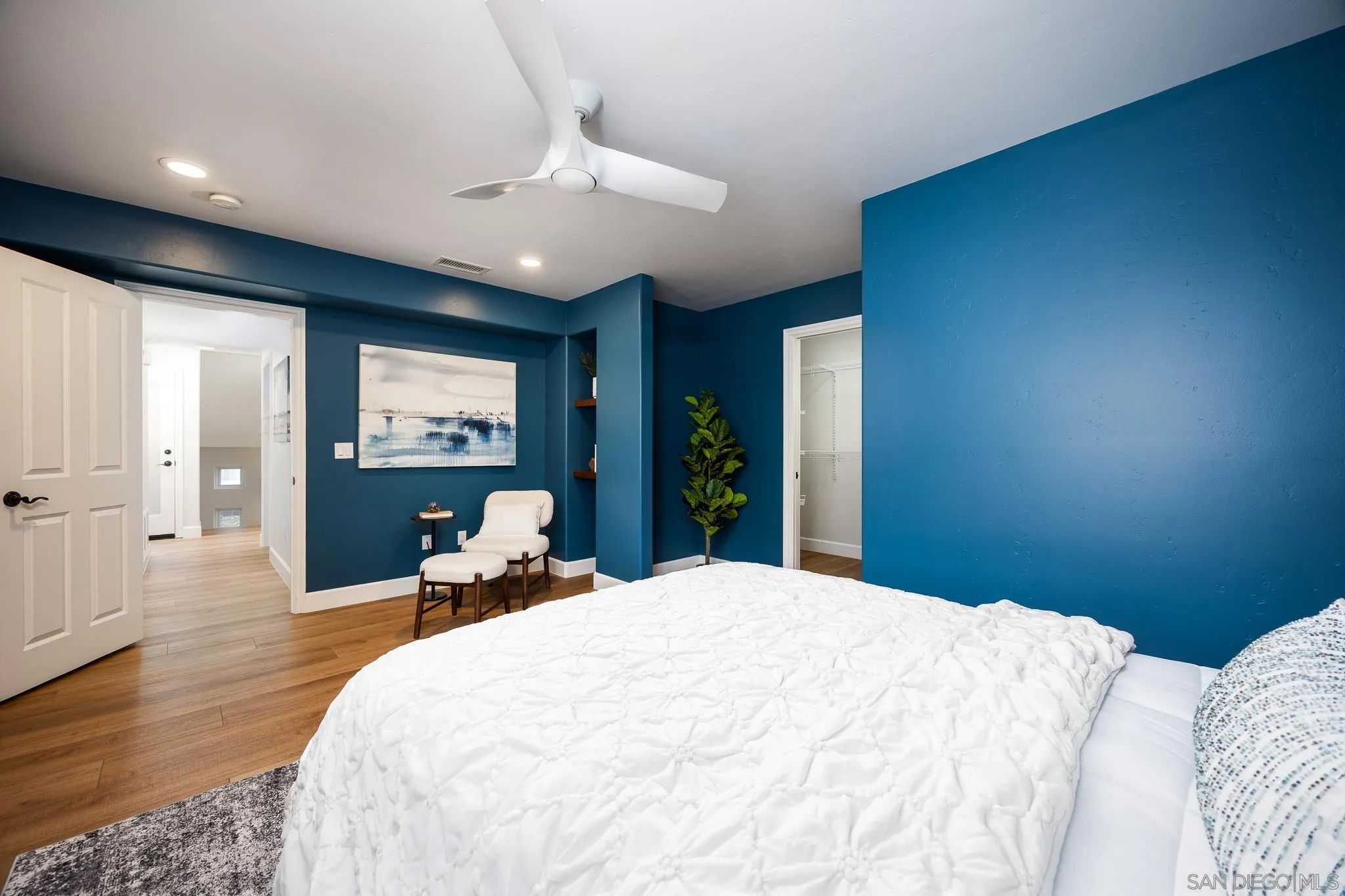 3986 Riviera Drive San Diego, CA 92109 - Photo 19 of 35 a bedroom with a bed and large mirror with wooden floor