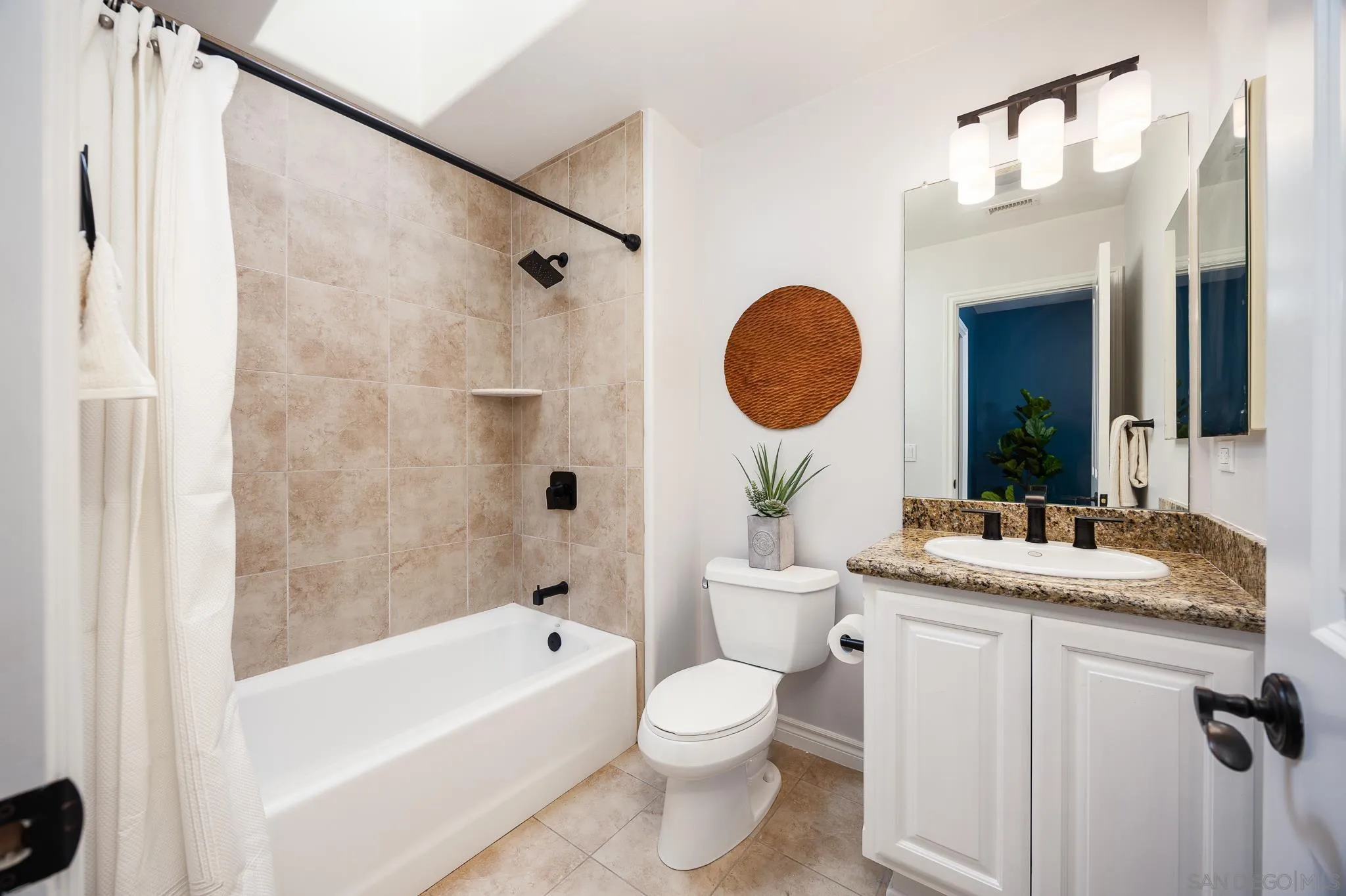 3986 Riviera Drive San Diego, CA 92109 - Photo 22 of 35 a bathroom with a granite countertop sink mirror toilet and bathtub