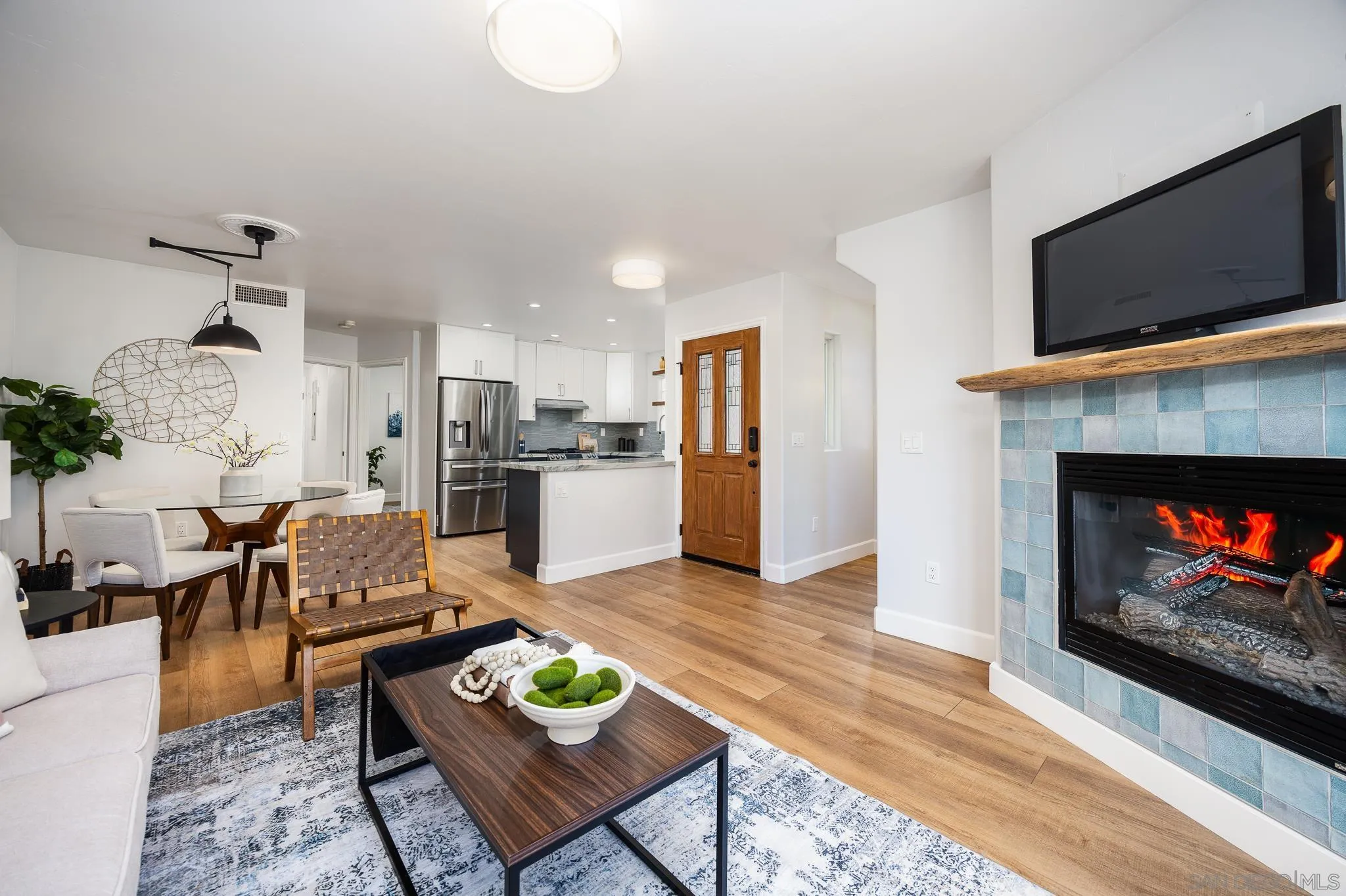 3986 Riviera Drive San Diego, CA 92109 - Photo 5 of 35 a living room with furniture and a fireplace with kitchen view