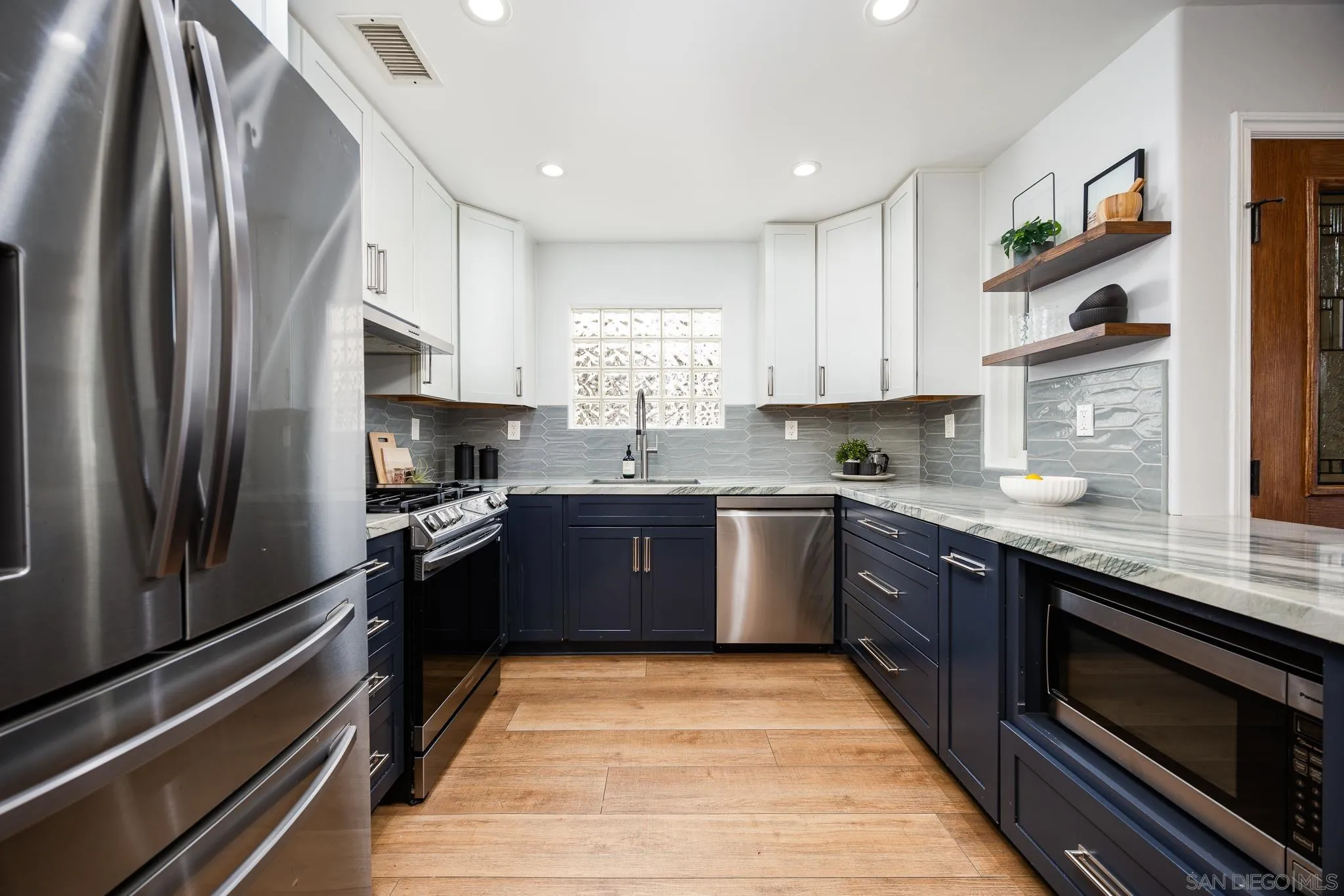 3986 Riviera Drive San Diego, CA 92109 - Photo 8 of 35 a kitchen with stainless steel appliances granite countertop a refrigerator sink and stove
