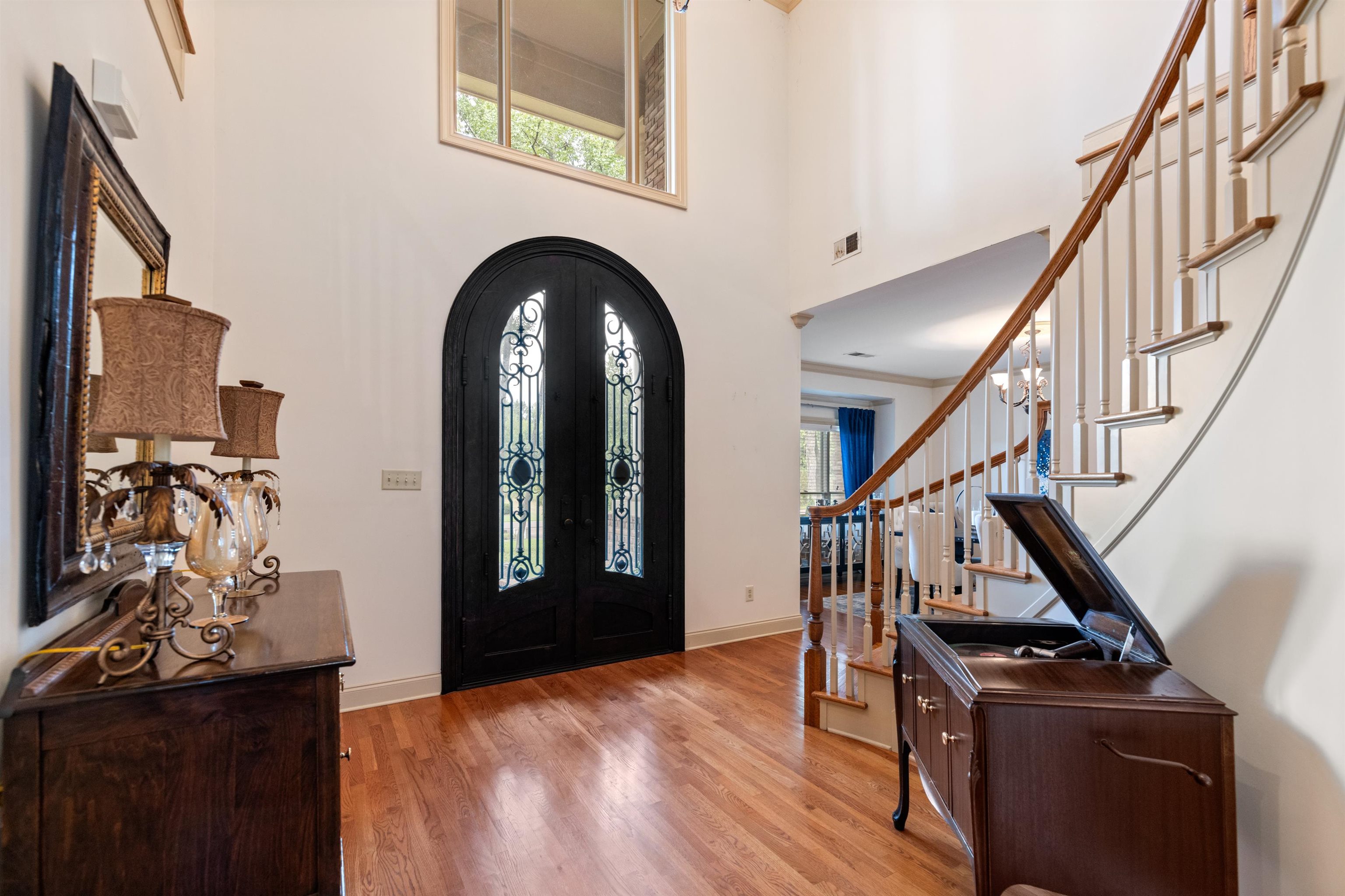 11241 Latting Road Eads, TN 38028 - Photo 6 of 31 Entrance foyer with ornamental molding, a towering ceiling, light wood-type flooring, and a healthy amount of sunlight