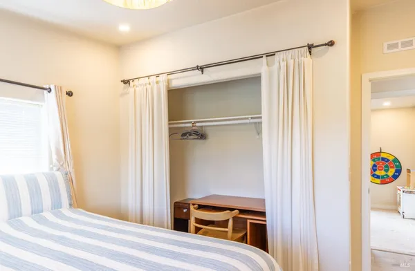 a bedroom with a bed and a closet