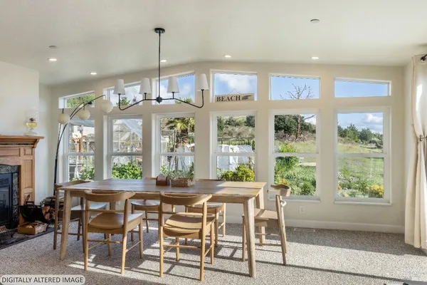a dining room with furniture a chandelier and wooden floor