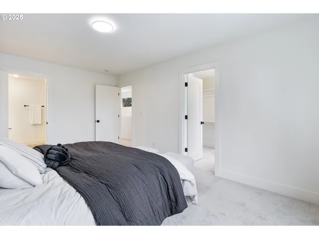 a bedroom with a bed and a painting on the wall