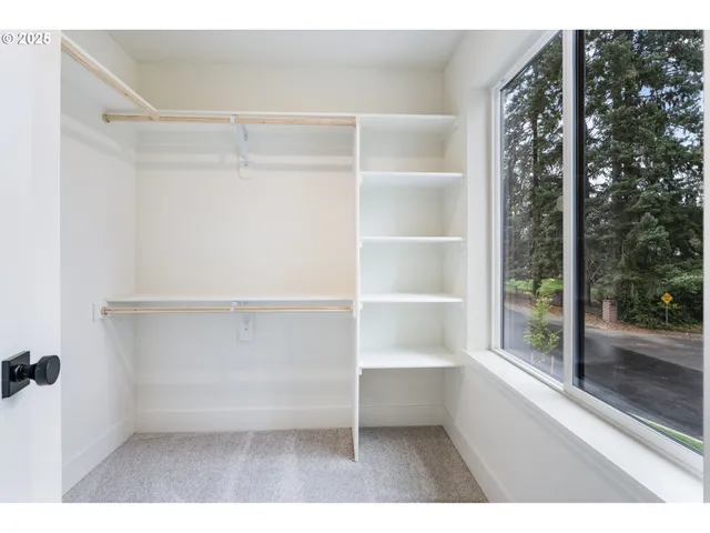 a view of a room with shelves on the wall