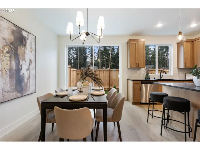 a dining room with furniture a chandelier and window