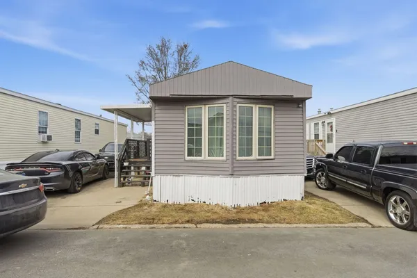 a front view of a house with parking space