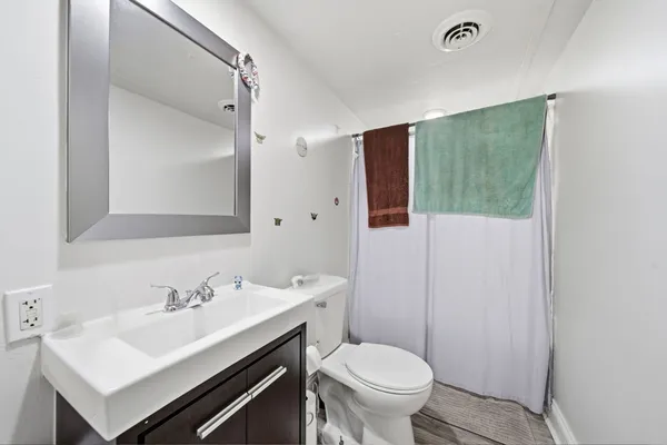 a bedroom with a bed and a dresser