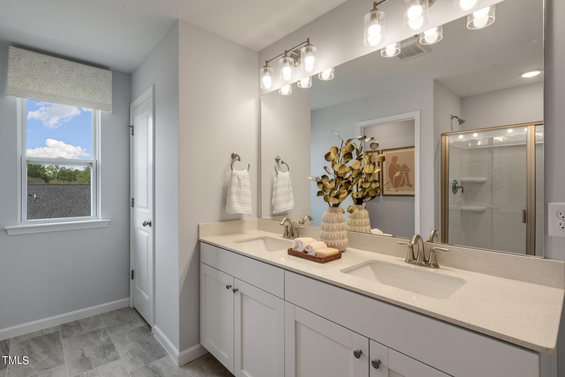 168 Siebold Street Garner, NC 27529 - Photo 15 of 59 a bathroom with a sink double vanity and a mirror