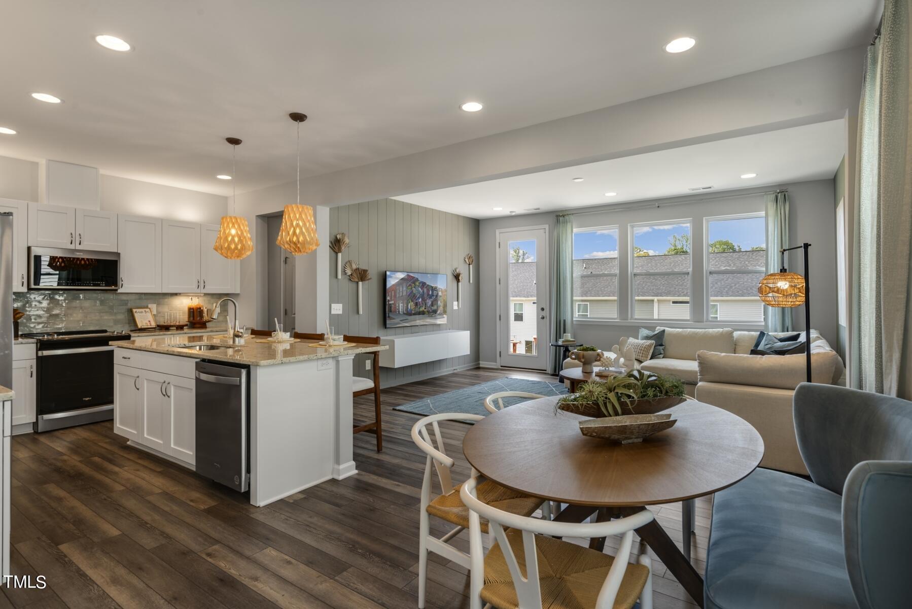 168 Siebold Street Garner, NC 27529 - Photo 29 of 59 a kitchen with a dining table and chairs