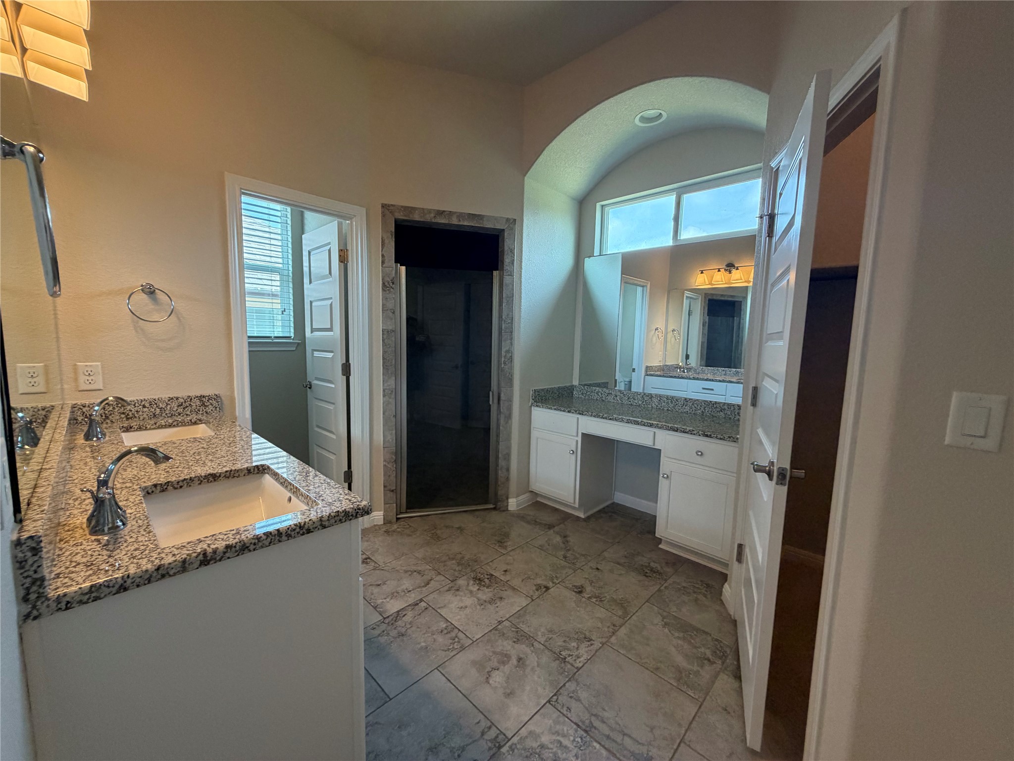 419 Gettysburg Loop Elgin, TX 78621 - Photo 9 of 21 Dual vanities and an arched transom window enhance this well-appointed bathroom.