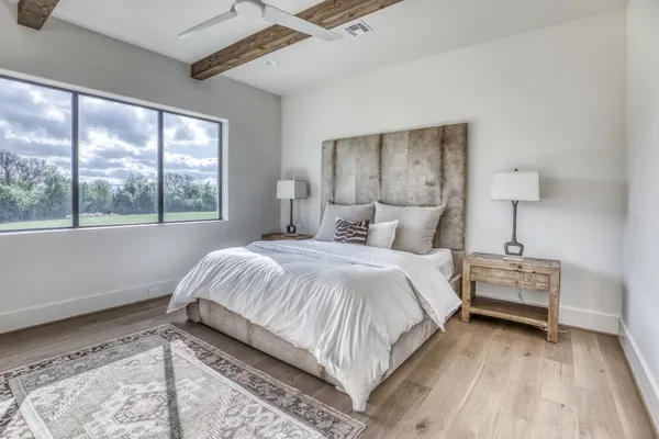 a bedroom with a bed and a large window