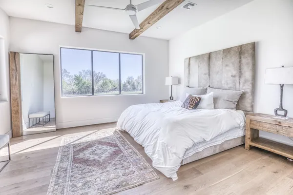 a bedroom with a large bed and a window