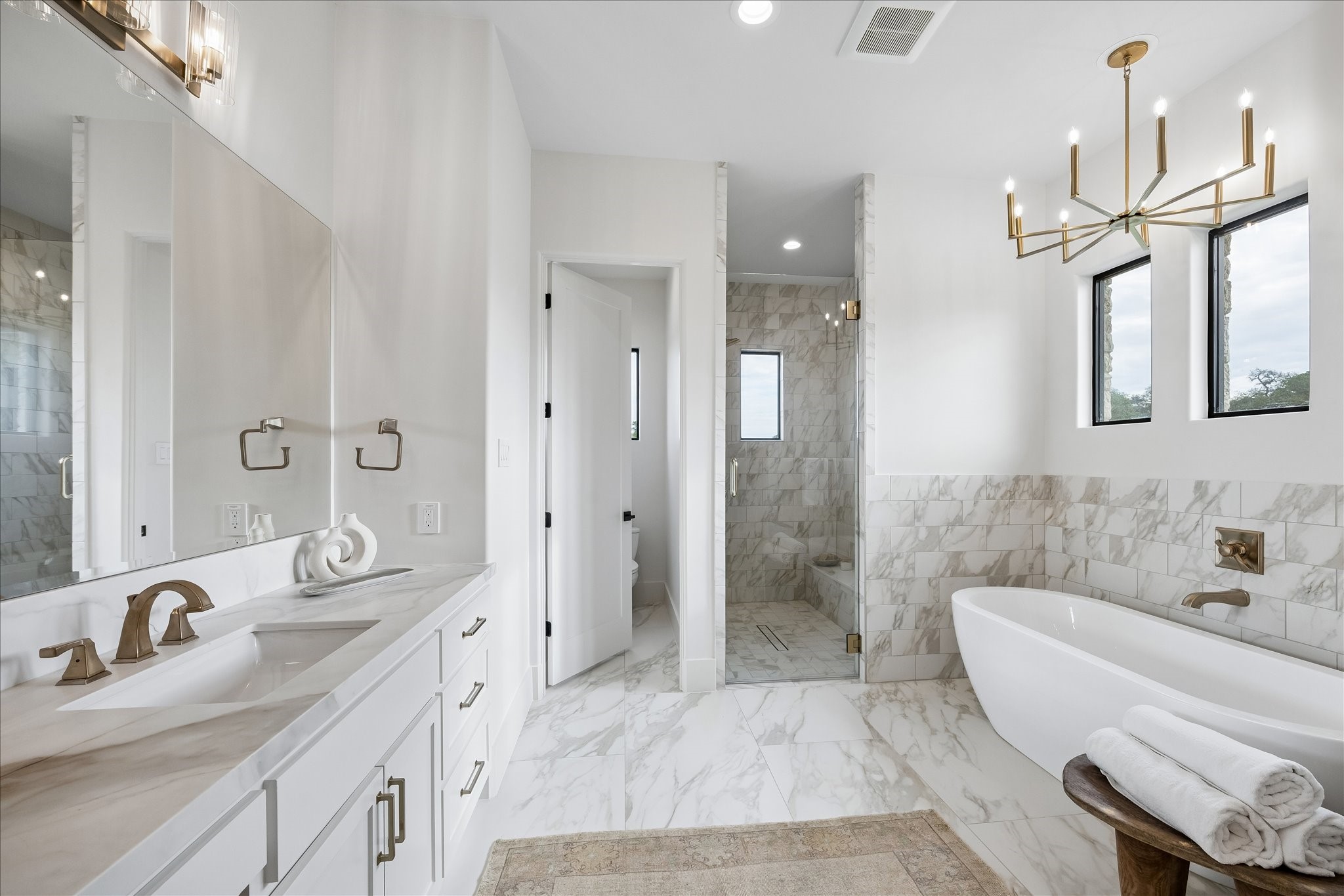 4961 Hartfield Road Round Top, TX 78954 - Photo 16 of 33 a spacious bathroom with a bathtub shower sink and mirror