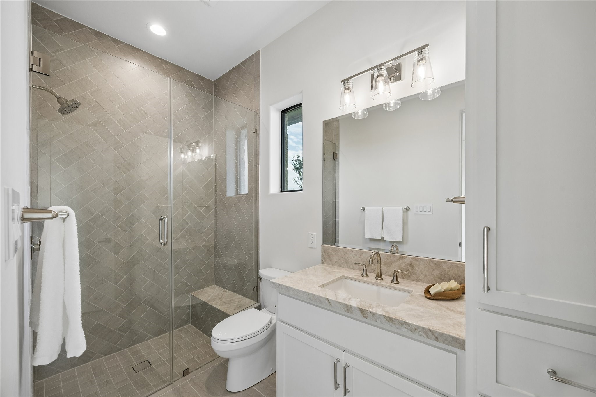 4961 Hartfield Road Round Top, TX 78954 - Photo 20 of 33 a bathroom with a granite countertop sink a toilet a mirror and shower