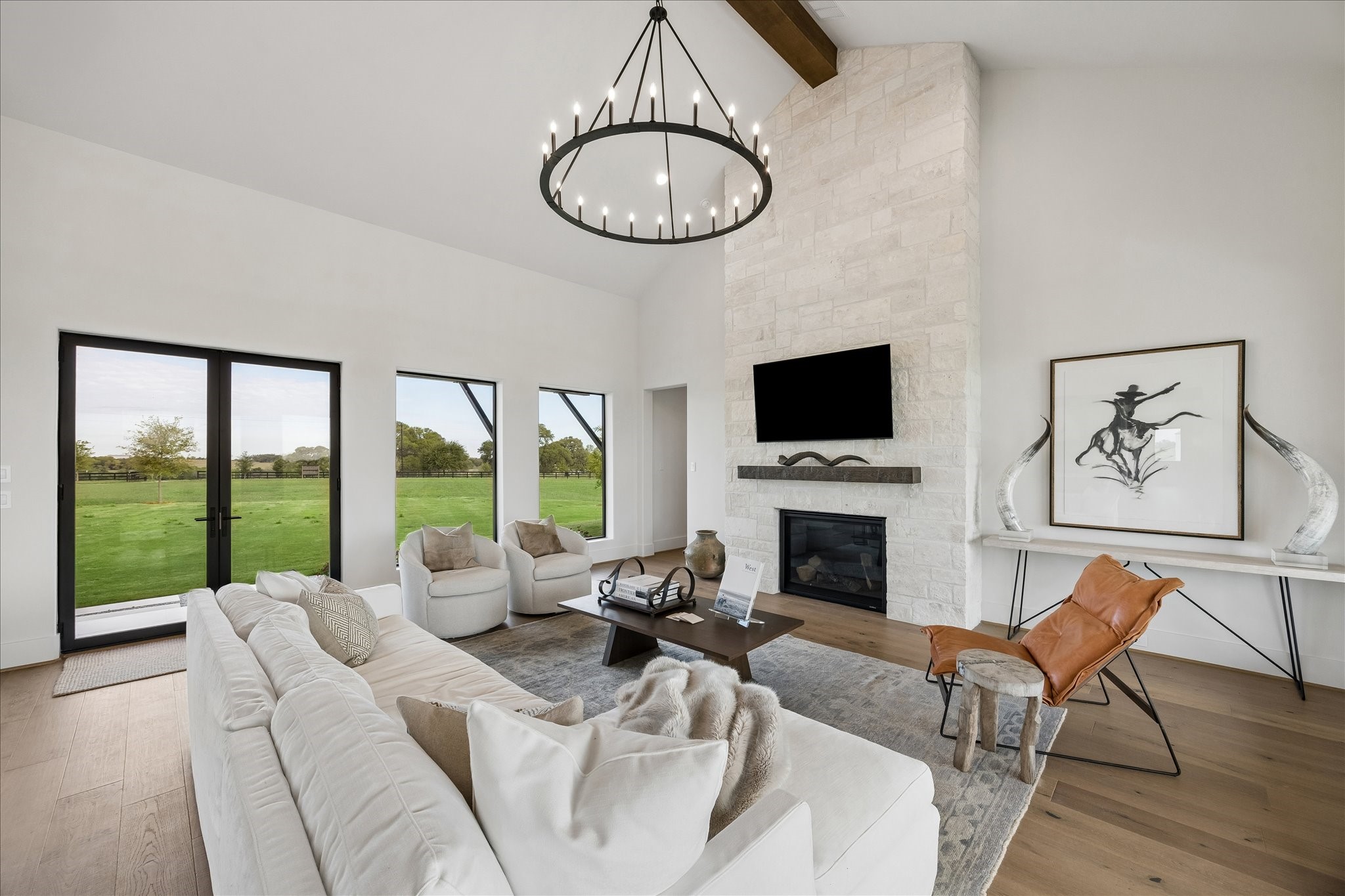 4961 Hartfield Road Round Top, TX 78954 - Photo 25 of 33 a living room with furniture a fireplace and a floor to ceiling window