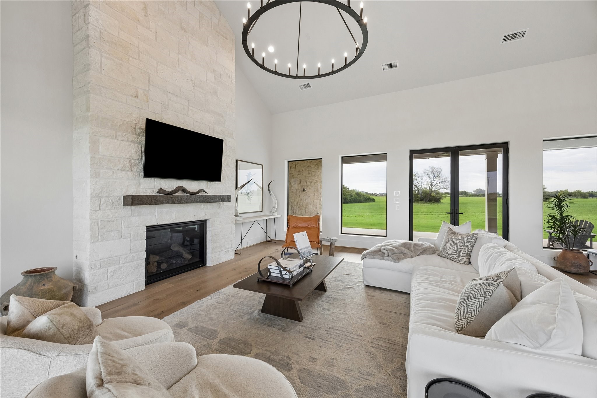 4961 Hartfield Road Round Top, TX 78954 - Photo 27 of 33 a living room with furniture a fireplace and a large window