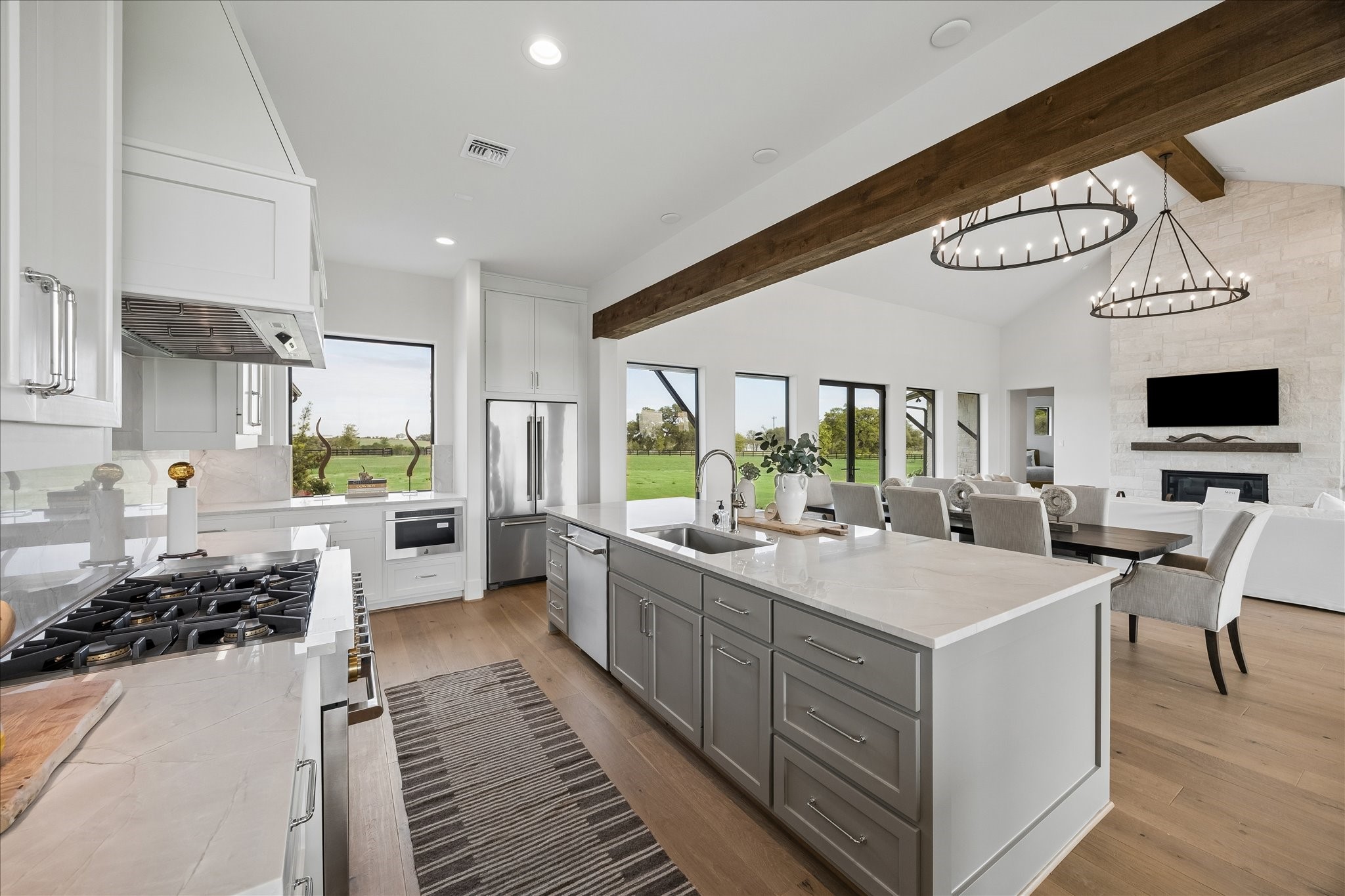 4961 Hartfield Road Round Top, TX 78954 - Photo 6 of 33 a large white kitchen with a large window a stove and a sink