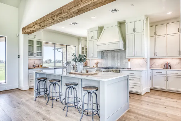 a kitchen with cabinets appliances and a center island
