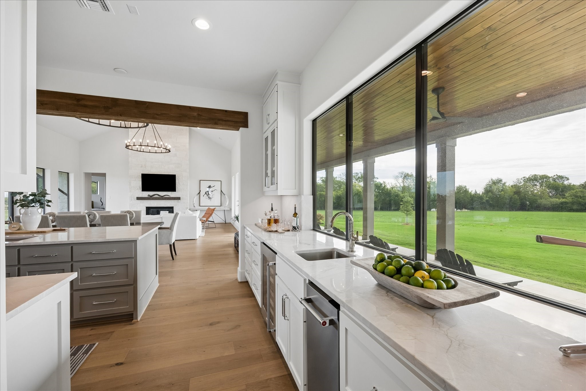 4961 Hartfield Road Round Top, TX 78954 - Photo 7 of 33 a large kitchen with kitchen island a large counter space a sink and stainless steel appliances