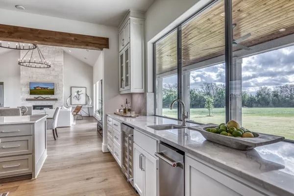 a kitchen with counter top space and living room