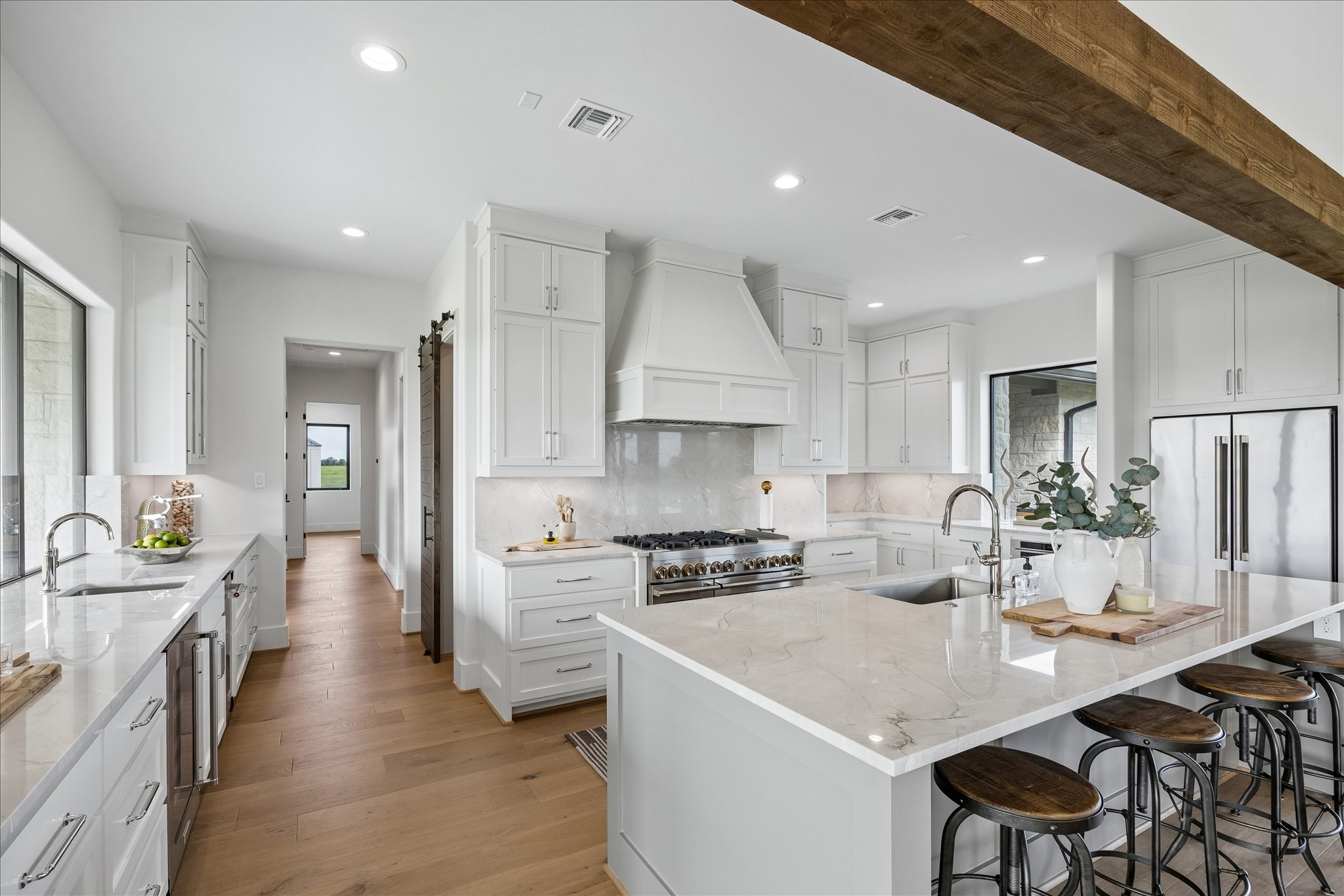 4961 Hartfield Road Round Top, TX 78954 - Photo 8 of 33 a kitchen with a sink a stove and chairs