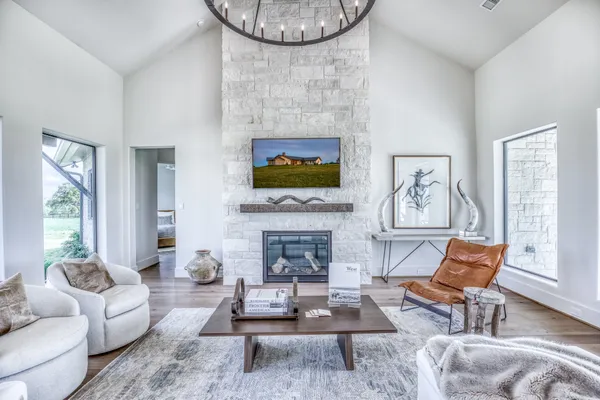 a living room with furniture a fireplace and a flat screen tv