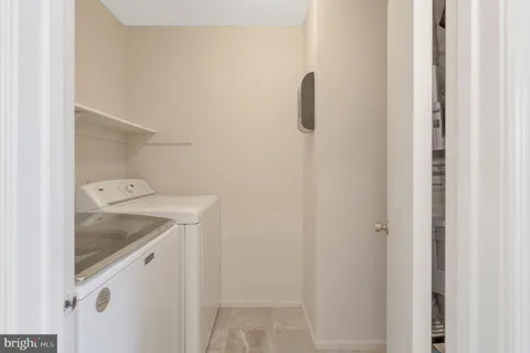 a bedroom with a bed dresser and a two windows