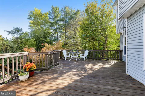 a view of a balcony with floor to ceiling windows and wooden fence