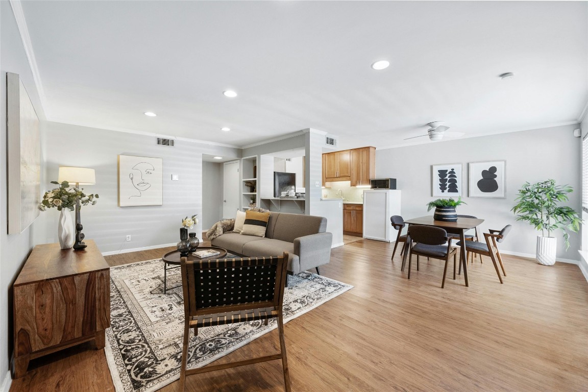 a living room with furniture and wooden floor